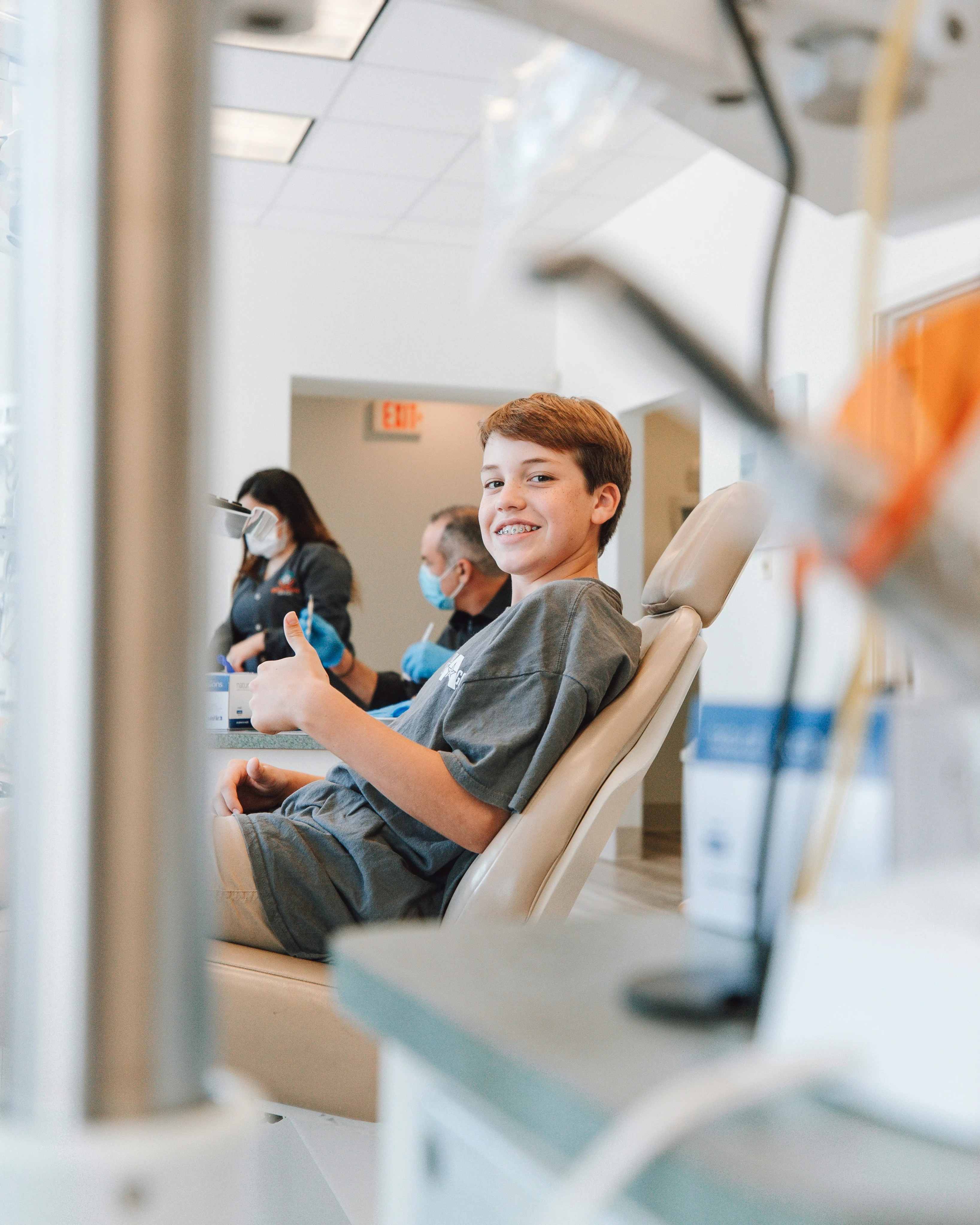 Happy patient with thumbs up after successful treatment